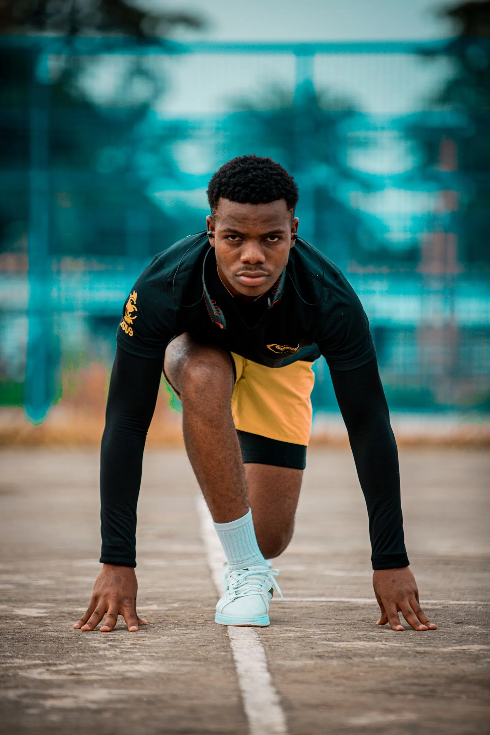 An athlete preparing to run on an outdoor track