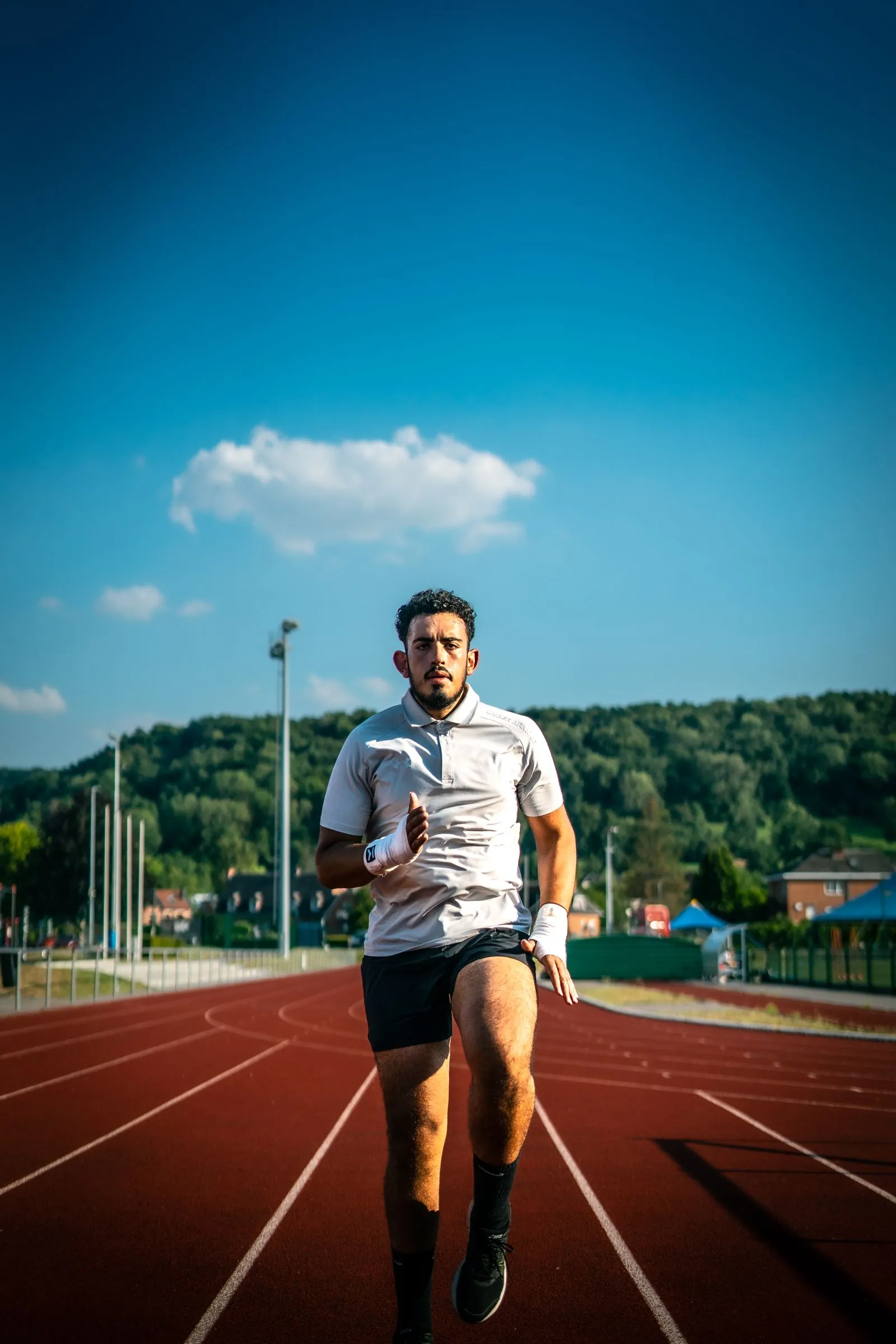 A runner training on a marked athletics track