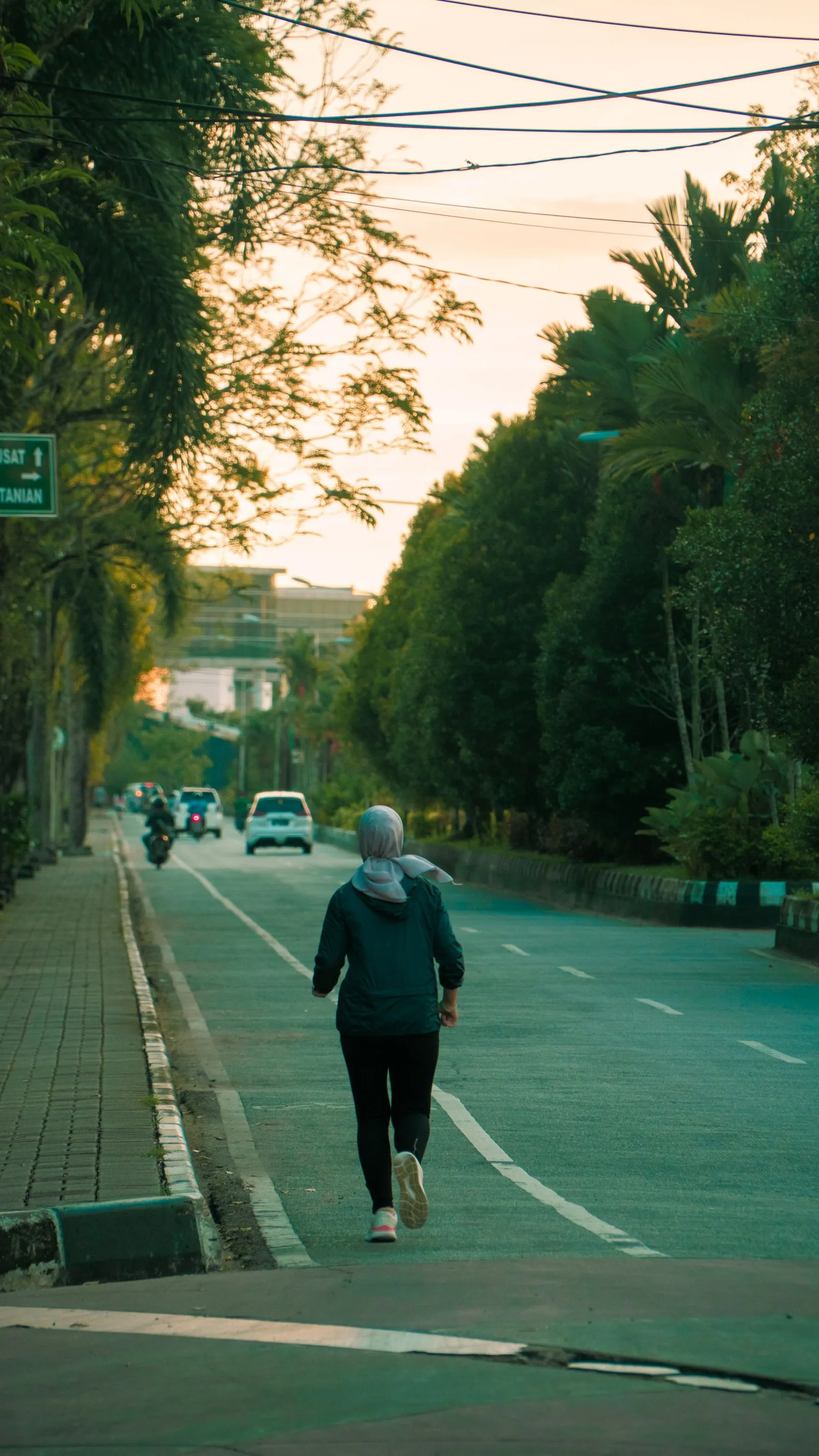 A runner seen from behind on a road