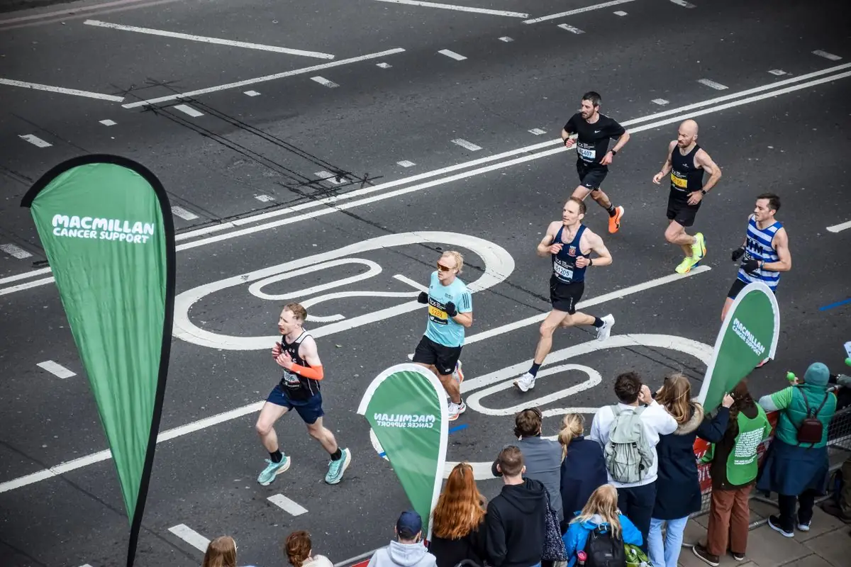 Runners participating in a marathon on London streets.