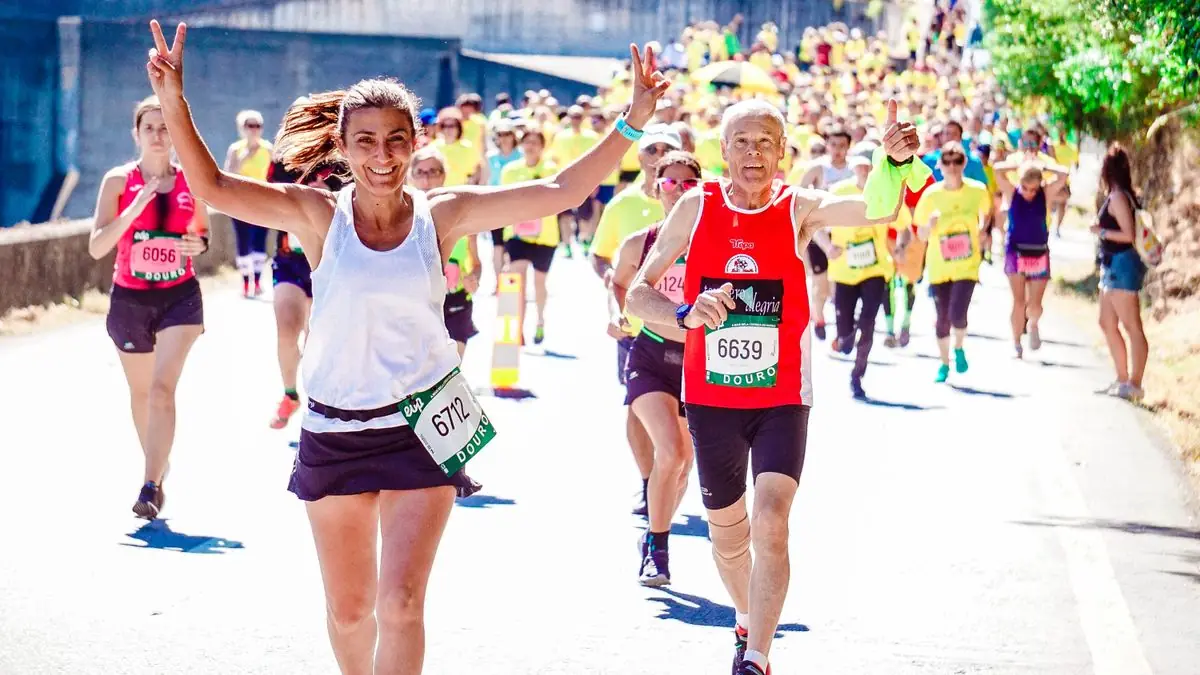 A group of diverse runners participating in a lively marathon event under the sun.