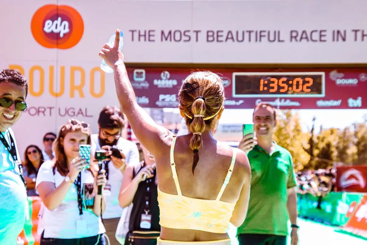 Runner celebrates at marathon finish line.