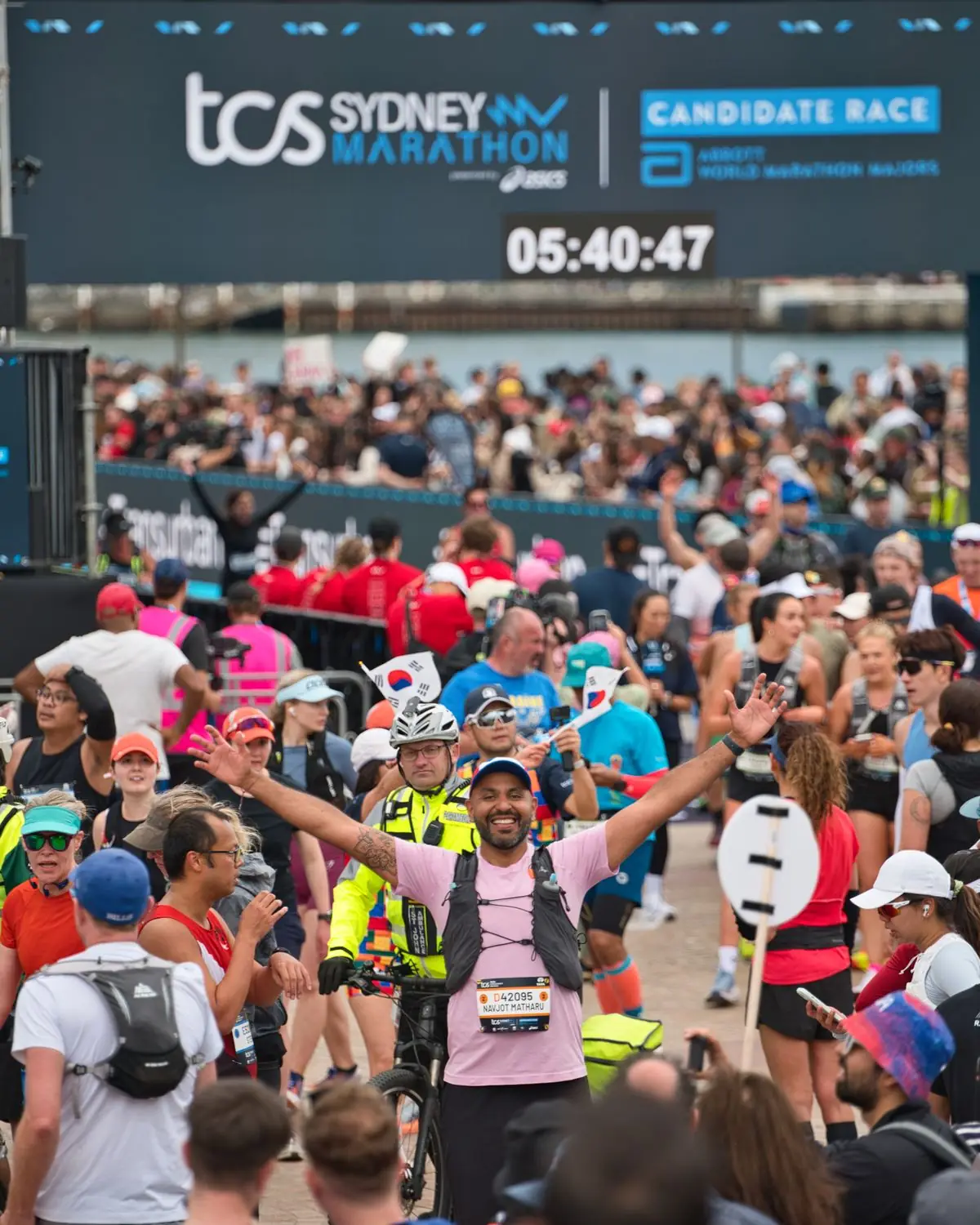 Joyful participants crossing the finish line at the Sydney Marathon.