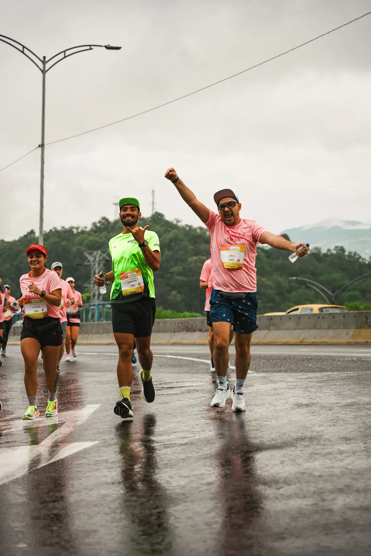 Cheerful runners participate in a rainy marathon.