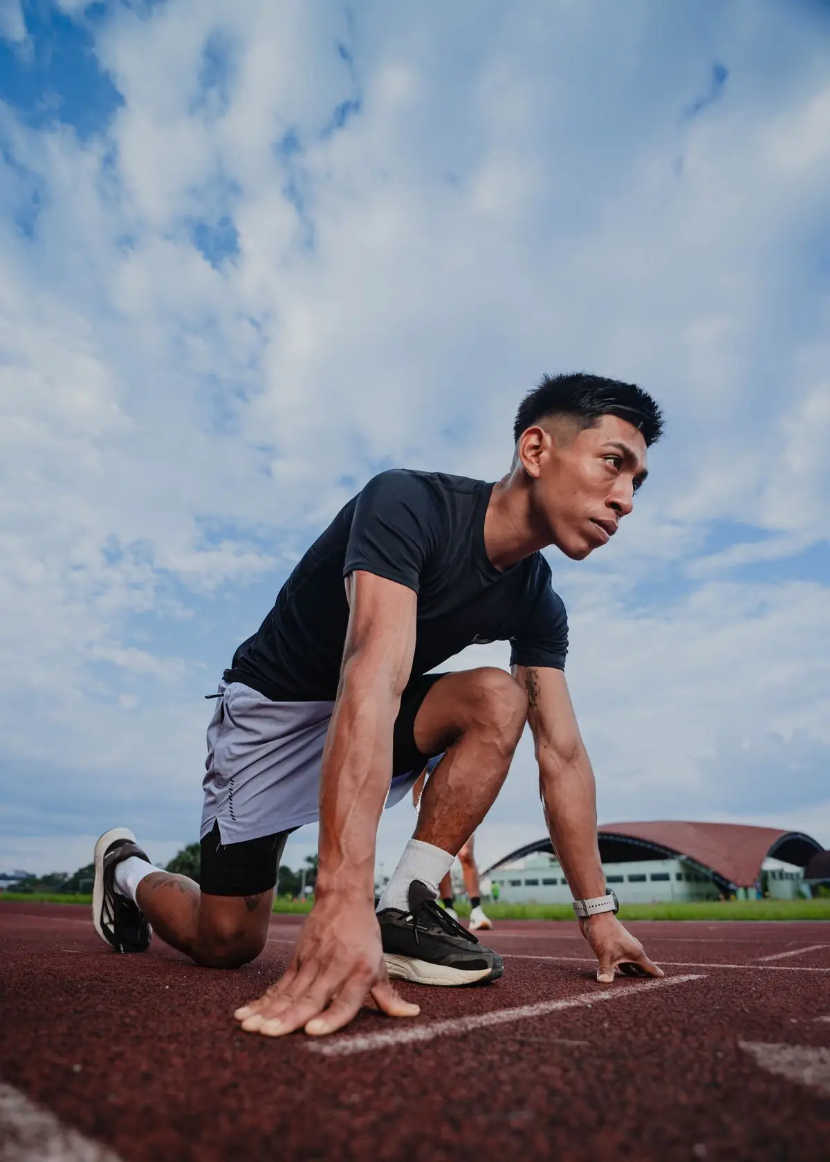 Young athlete crouched at the starting line.