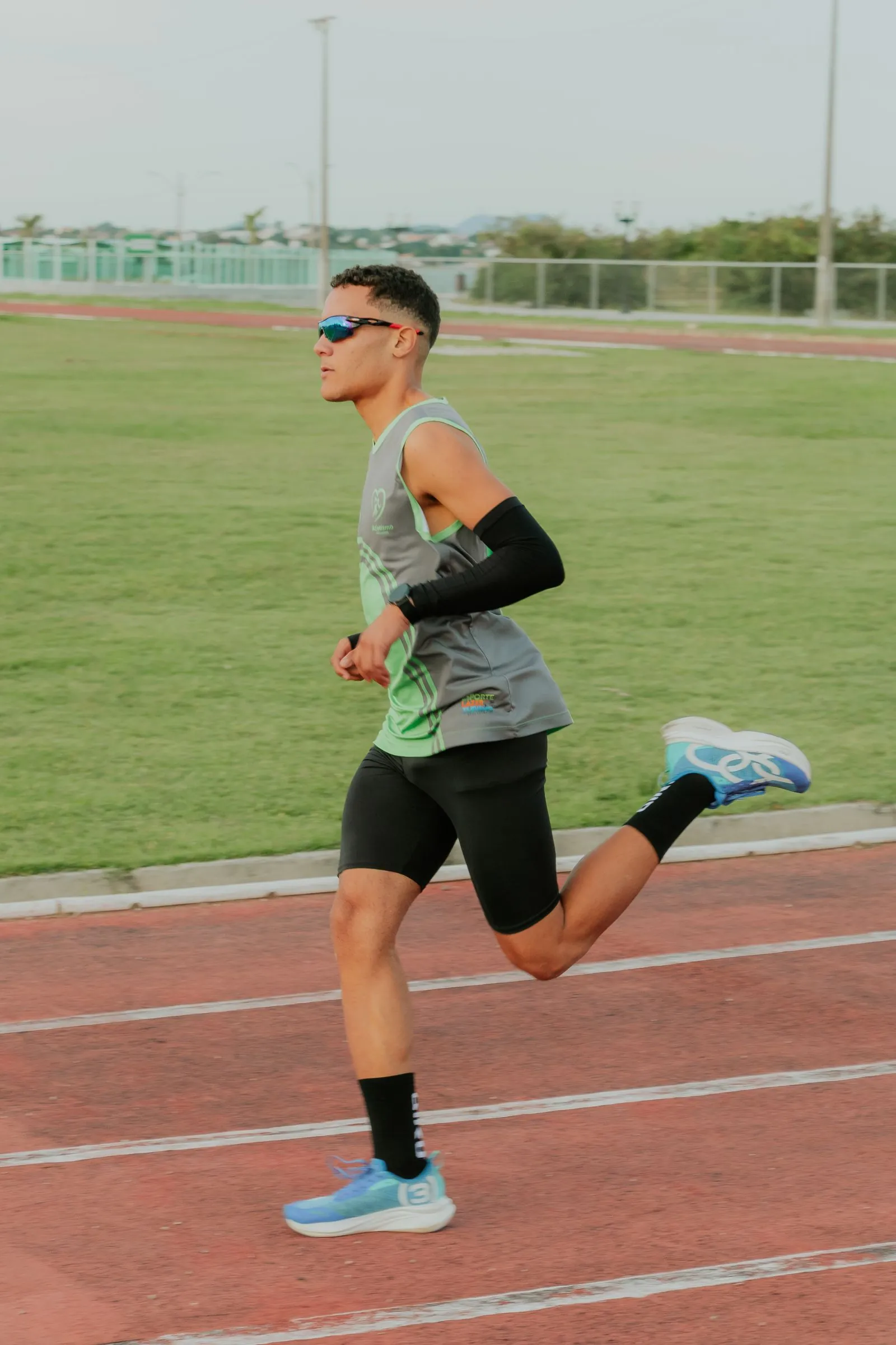 A runner training on an outdoor track