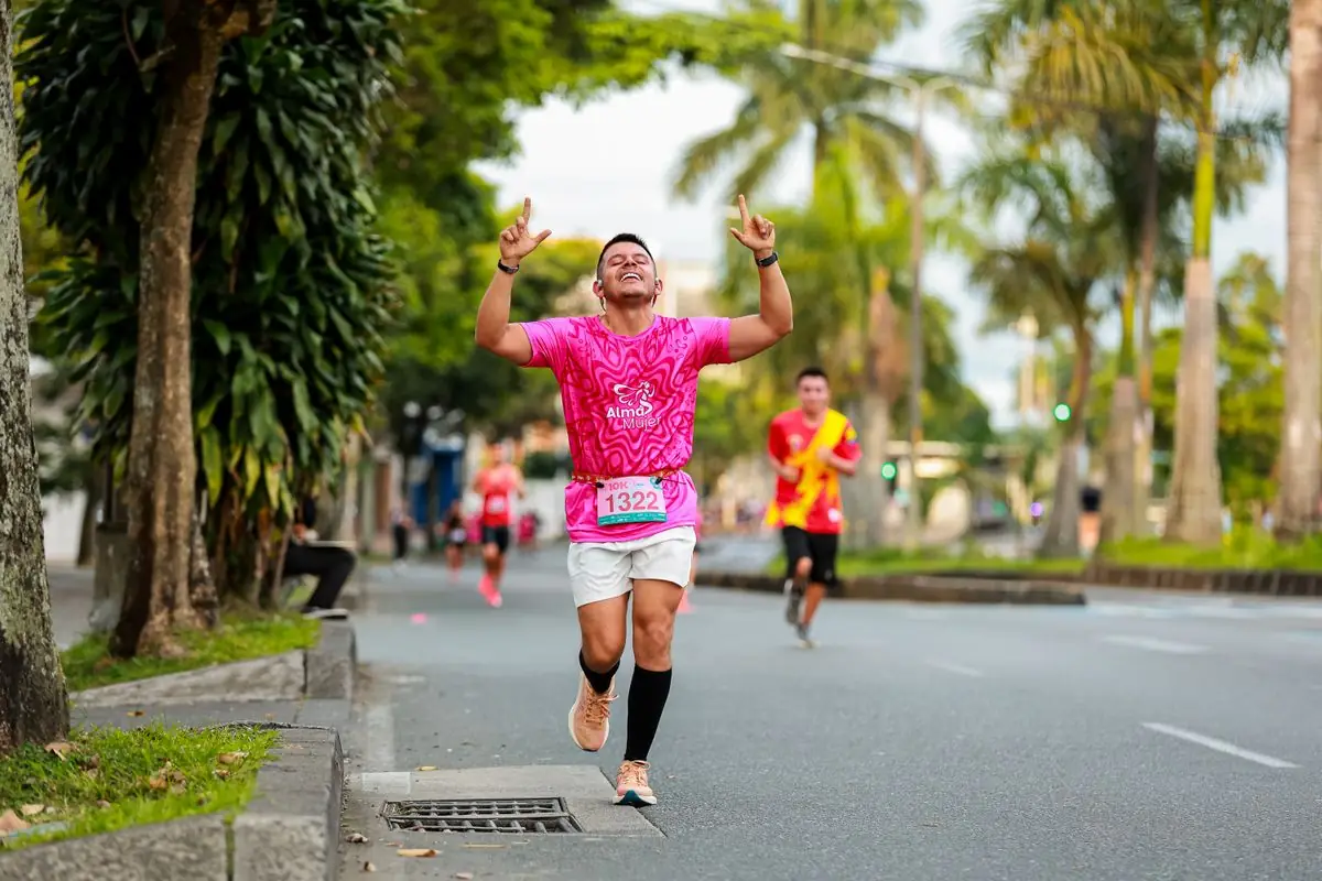 Excited runner celebrates crossing the finish line during a city marathon event.