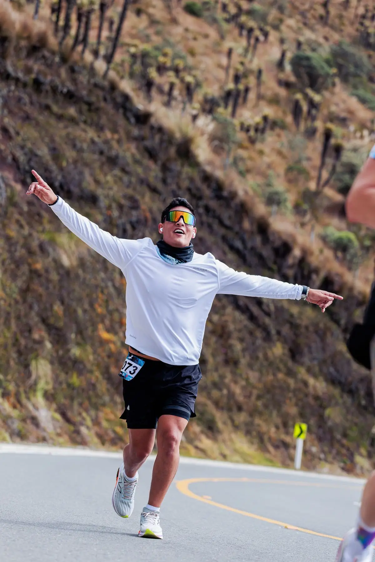Happy runner celebrating at the finish line of a marathon.