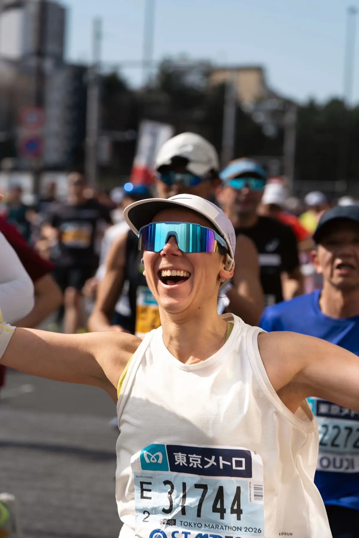 Excited runner celebrates crossing the finish line at the Tokyo Marathon.