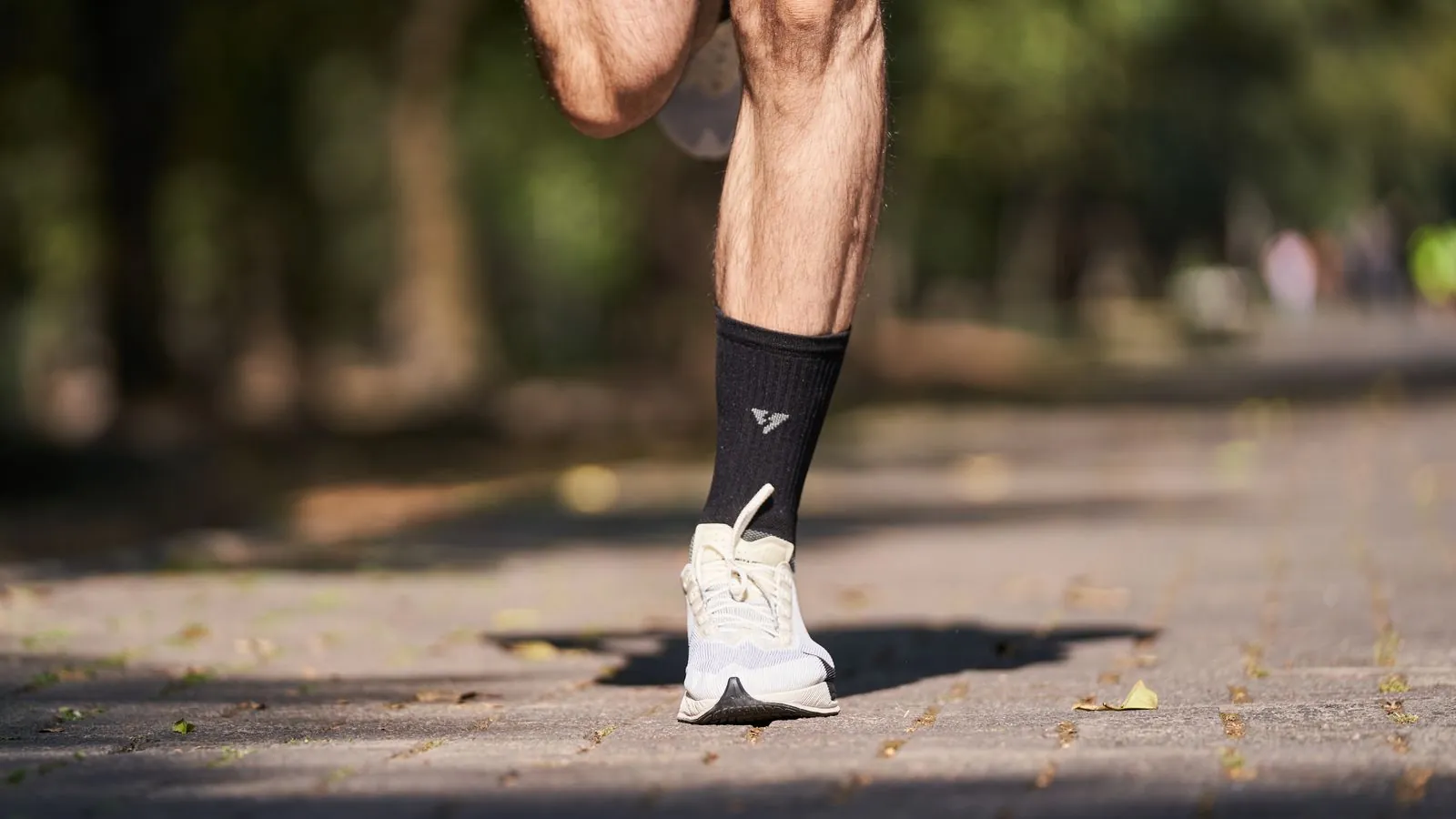 A close view of a runner moving through a park
