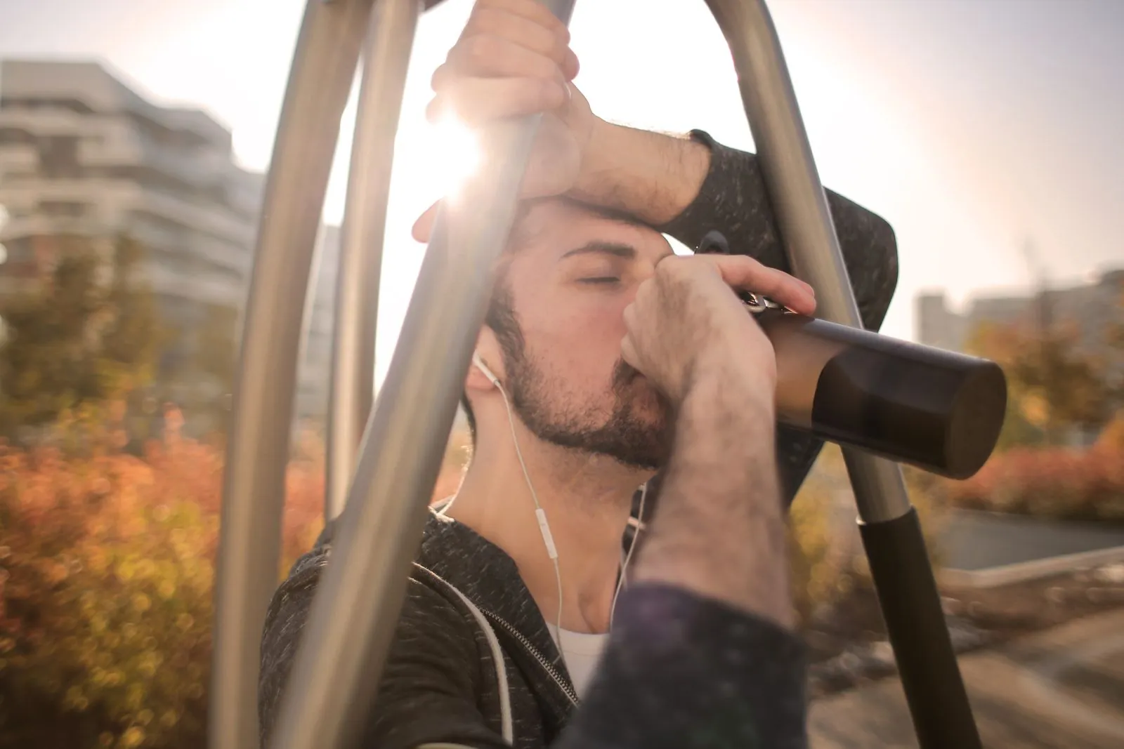A runner taking a water break on an outdoor route