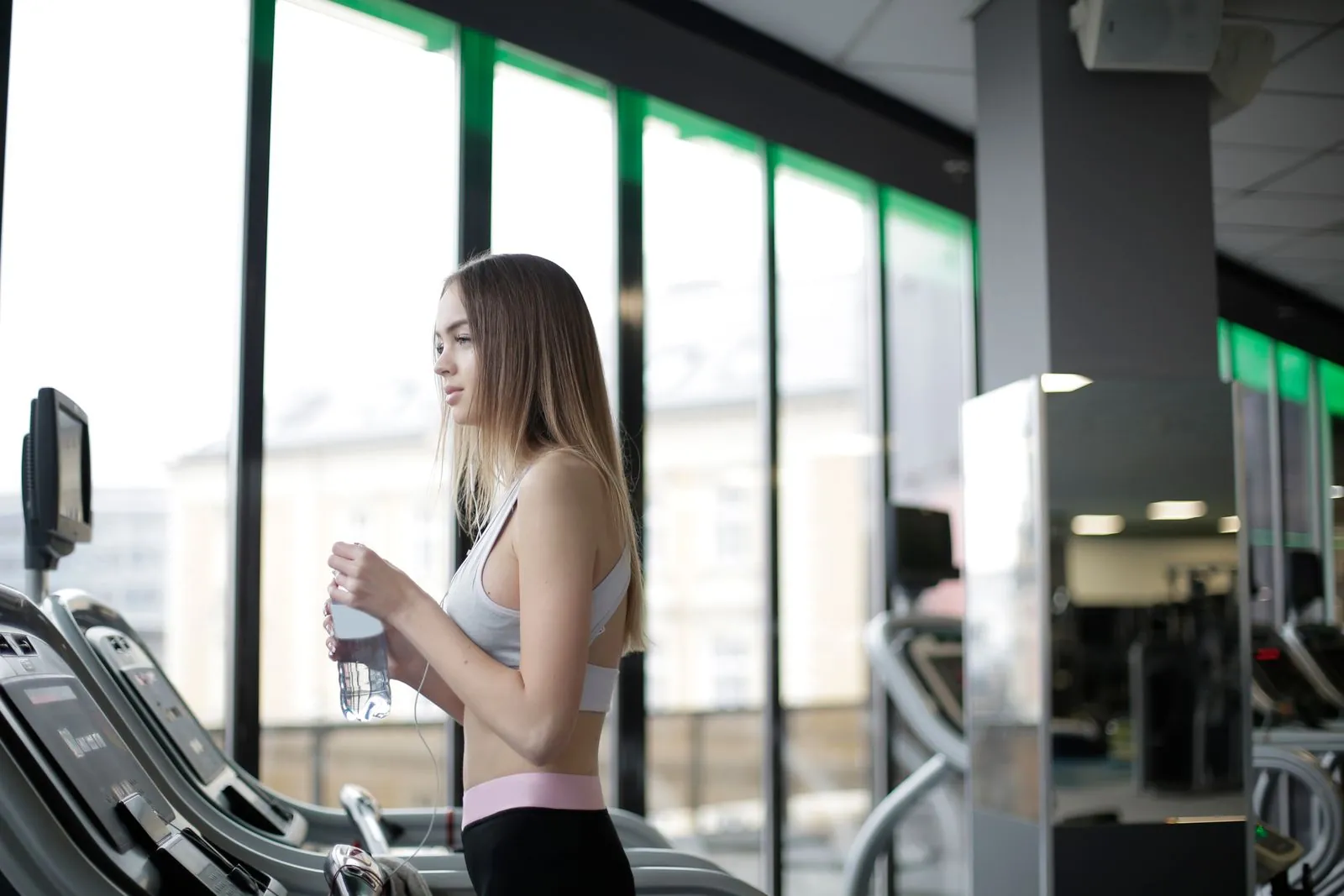 A runner training on a treadmill in a gym