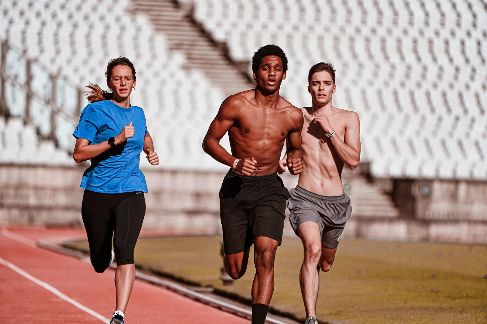 Athletes running together on a track