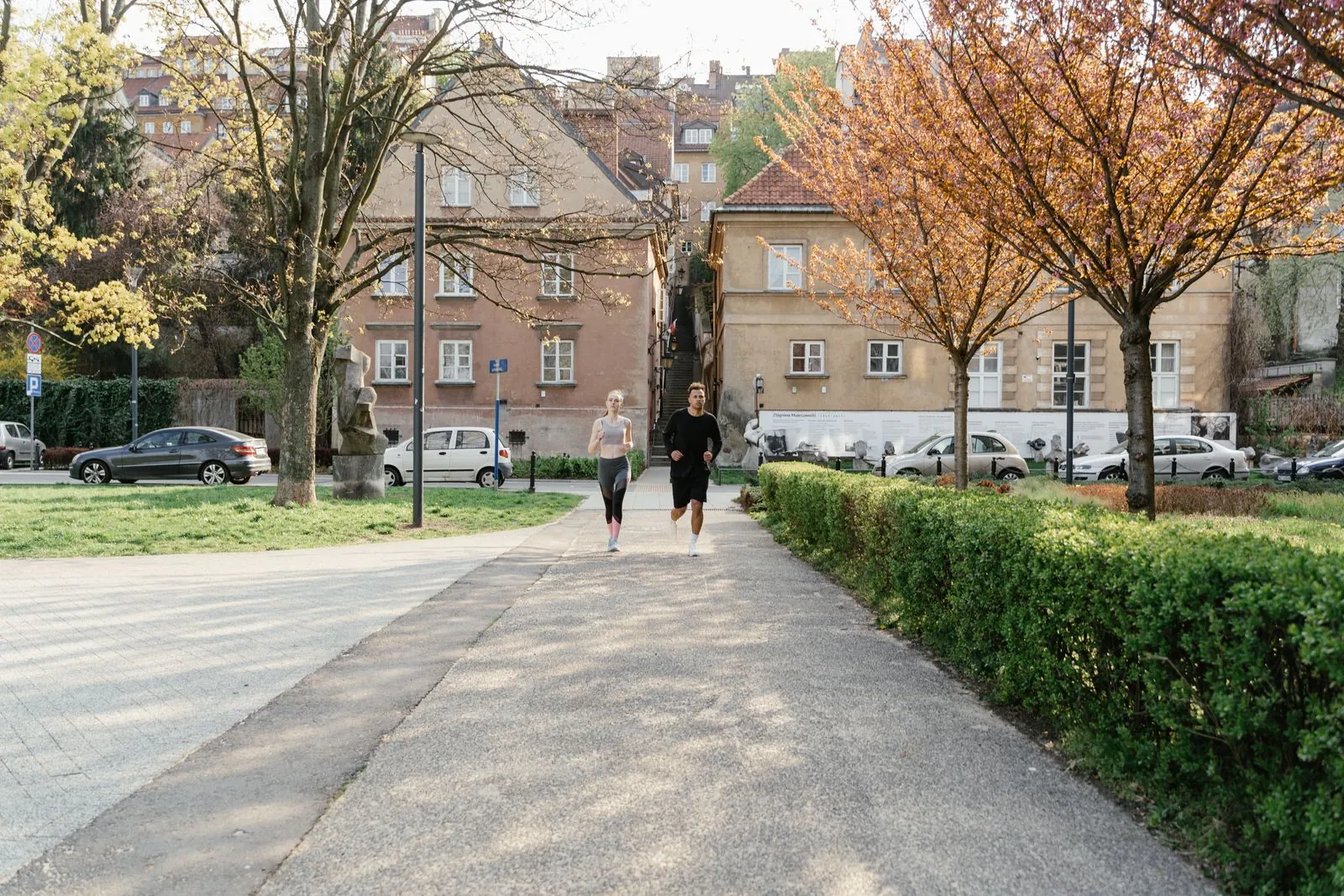 Two runners jogging outdoors during the day
