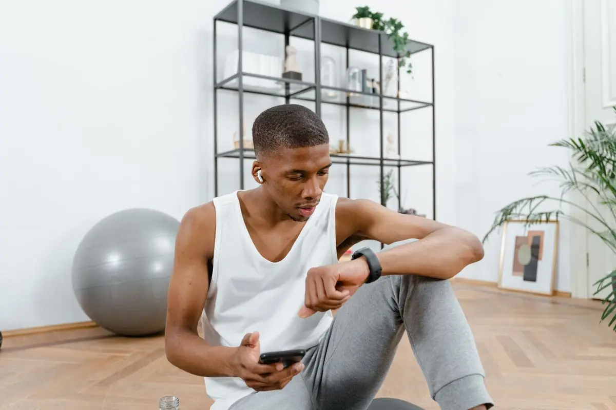 Young man in active wear resting indoors.