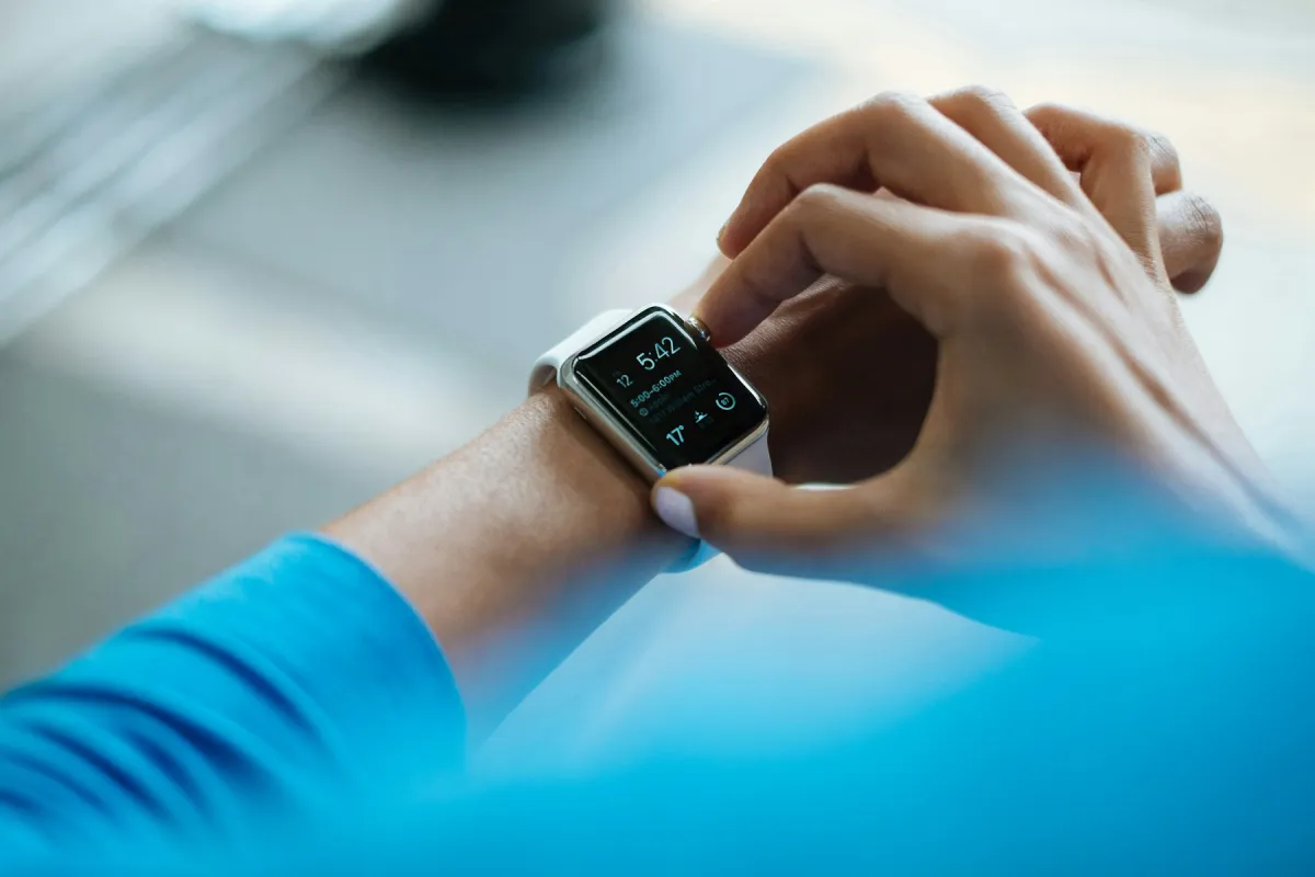 A runner checking a watch during a workout